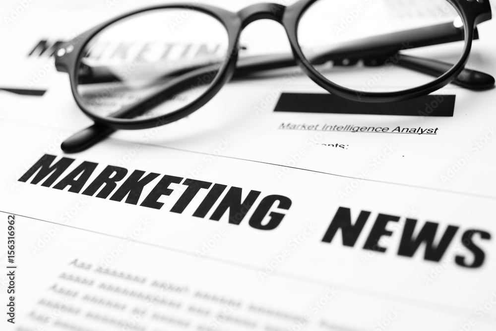 Paper sheet with text MARKETING NEWS, closeup Paper sheet with text MARKETING NEWS, closeup