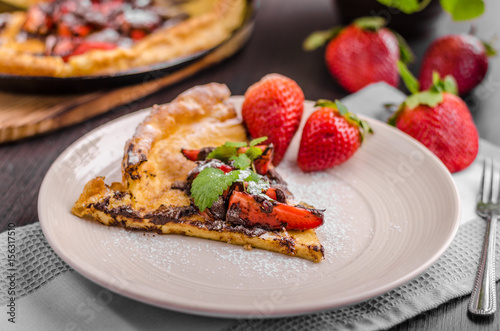 Pancake in oven, dutch baby pancake with strawberries