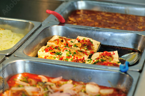 Steel tray filled with food inside the self service Chinese restaurant