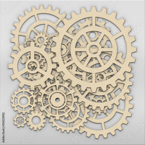 Gears from clock works over light grey metalic plate
