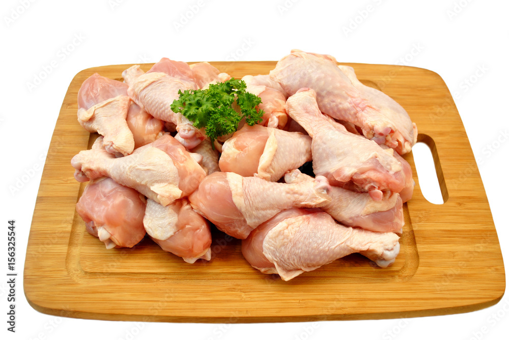 Raw Fresh Chicken Legs on a Wooden Cutting Board Raw Fresh Chicken Legs on a Wooden Cutting Board