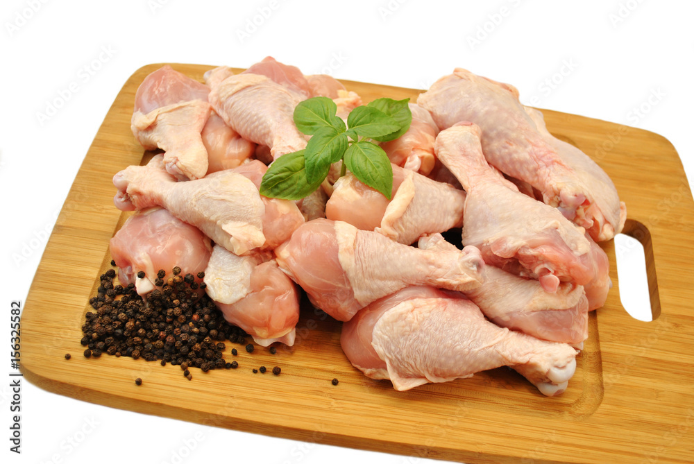 Raw Fresh Chicken Legs on a Wooden Cutting Board Raw Fresh Chicken Legs on a Wooden Cutting Board