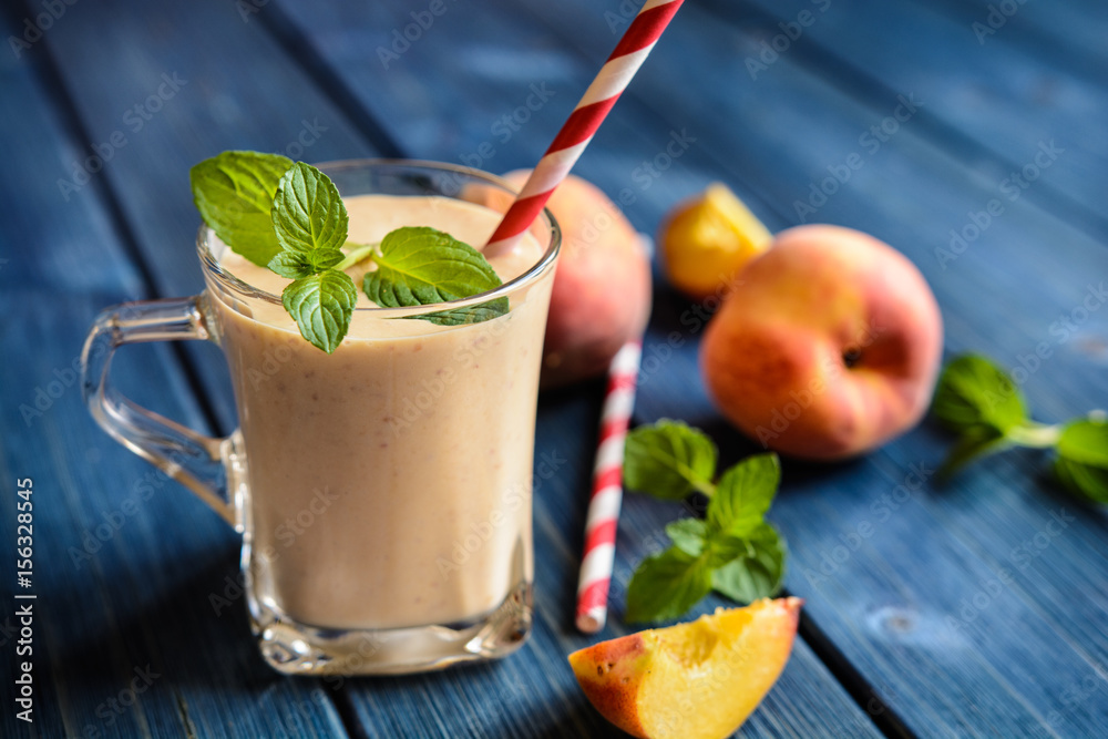 Healthy peach milkshake in a glass jar Healthy peach milkshake in a glass jar