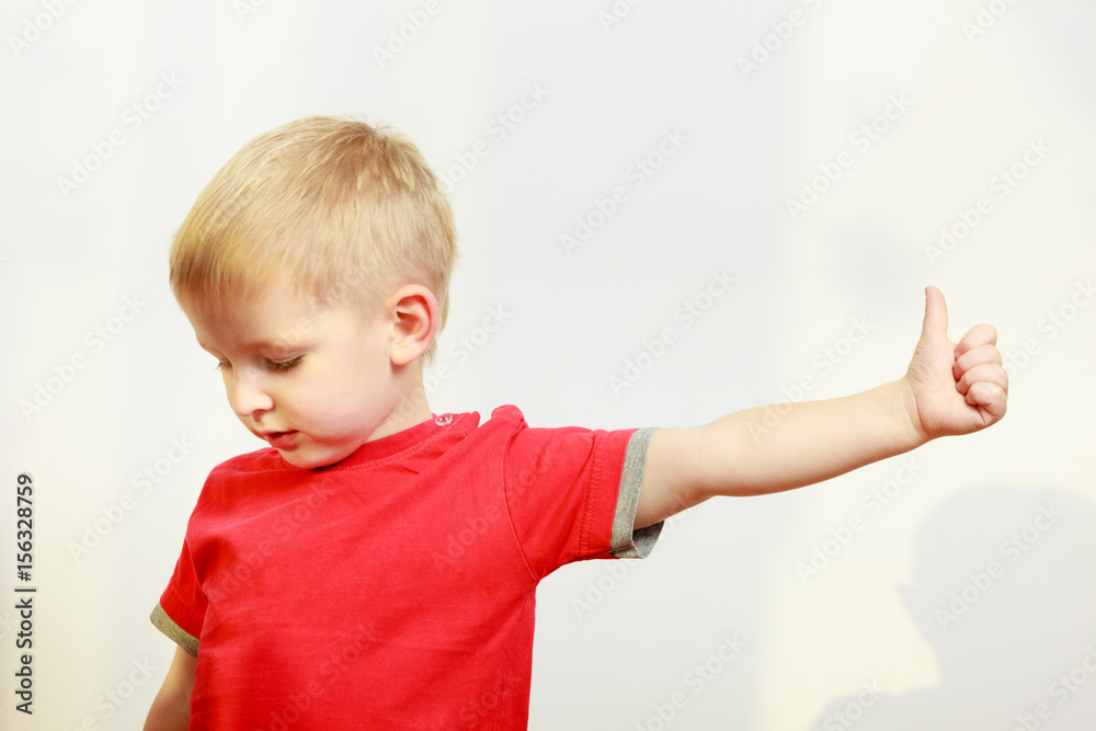 Little boy playing showing thumb up gesture Little boy playing showing thumb up gesture