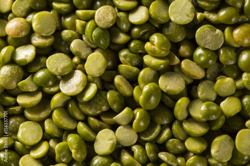 Obraz na płótnie Green lentils in wooden bowl on wood background. Edible raw pulses of the legume family. w salonie