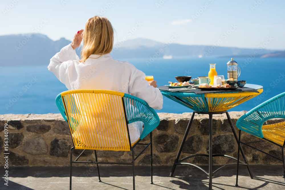 Obraz premium Woman enjoying morning in luxury hotel in Santorini