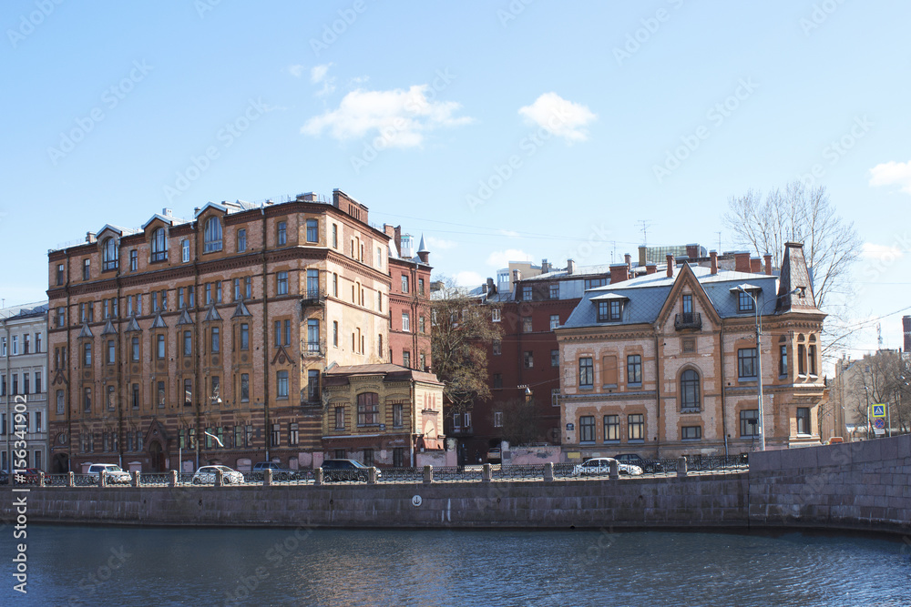 Several city houses on the river bank.