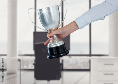 business hand with trophy in the office