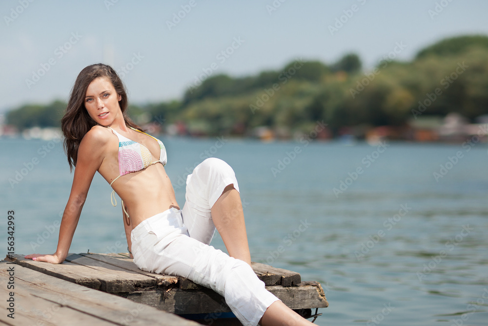 young girl on river bank .summer day