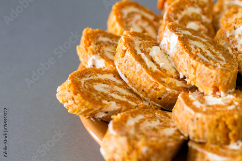 Wallpaper Mural Cutting roll with carrot omelette and ricotta cheese with garlic on orange plate.  Torontodigital.ca