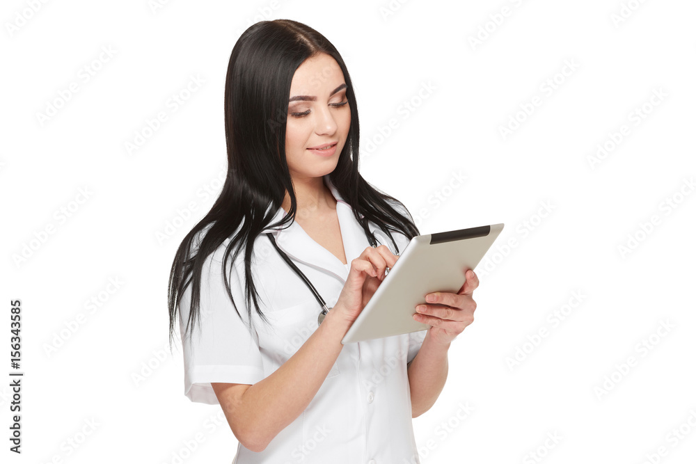 Doctor in uniform using tablet and reading information about patient. Doctor in uniform using tablet and reading information about patient.