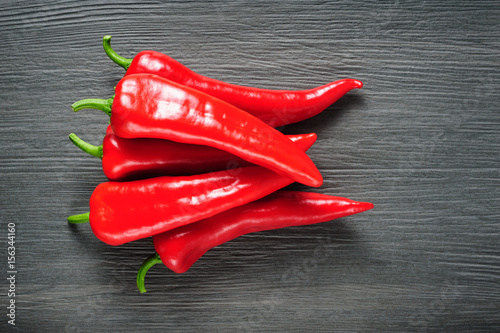 Sweet red Kapia peppers on a dark shale stone background photo