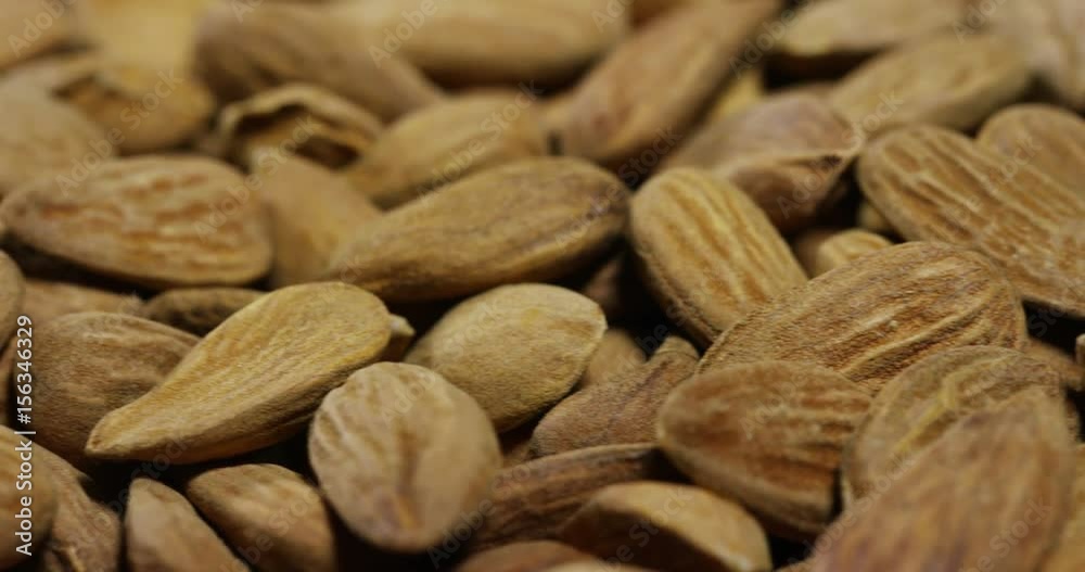 Close-up of light brown almonds. Concept: salted, nuts, seeds, tasty, healthy, fresh product, shrub or small tree from the subgenus Almonds of the genus Plum, proper nutrition and energy. Close-up of light brown almonds. Concept: salted, nuts, seeds, tasty, healthy, fresh product, shrub or small tree from the subgenus Almonds of the genus Plum, proper nutrition and energy.