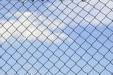 Sky behind the fence. The concept of freedom security loneliness imprisonmentrefugee