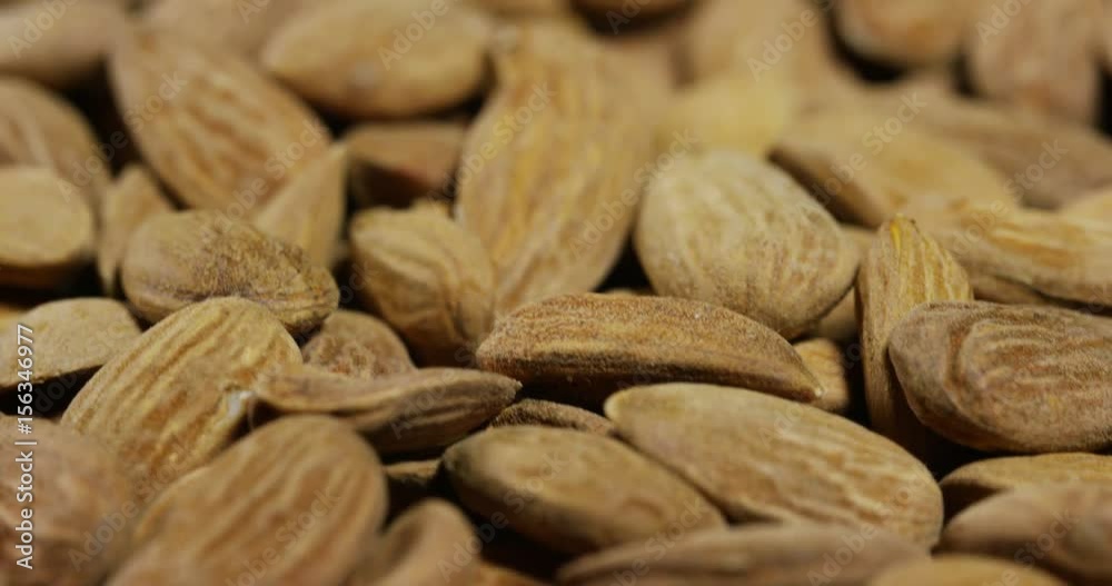 Close-up of light brown almonds. Concept: salted, nuts, seeds, tasty, healthy, fresh product, shrub or small tree from the subgenus Almonds of the genus Plum, proper nutrition and energy. Close-up of light brown almonds. Concept: salted, nuts, seeds, tasty, healthy, fresh product, shrub or small tree from the subgenus Almonds of the genus Plum, proper nutrition and energy.