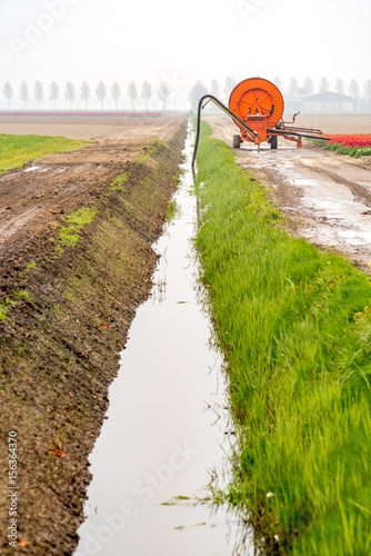 Fototapeta Naklejka Na Ścianę i Meble -  Spraying machine on the tulip field