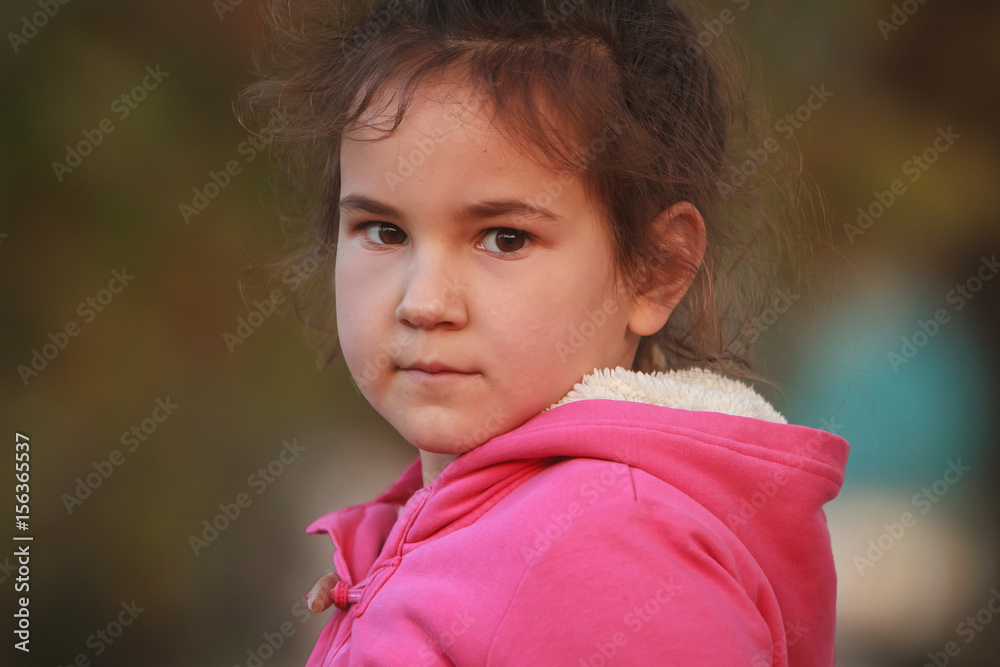 outdoor portrait of young happy child girl playing in park on natural background outdoor portrait of young happy child girl playing in park on natural background