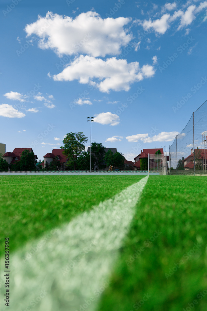 Soccer football net background over green grass and blurry stadium. Soccer football net background over green grass and blurry stadium.