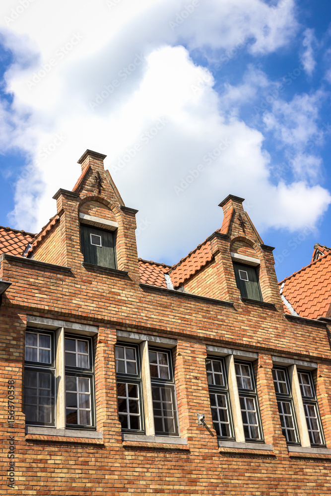 Old brick houses and blue sky in Bruges, Belgium