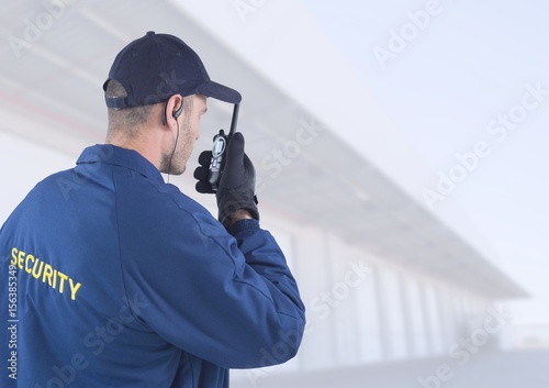 Security man outside bright background warehouses