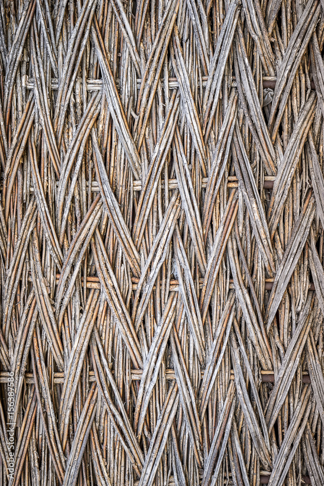 Background, texture of wicker dry branches, on the whole frame. Vertical frame Background, texture of wicker dry branches, on the whole frame. Vertical frame