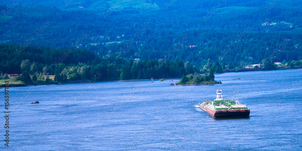 Naklejka premium Small tug pushing huge barge Columbia River scenic Columbia Gorge