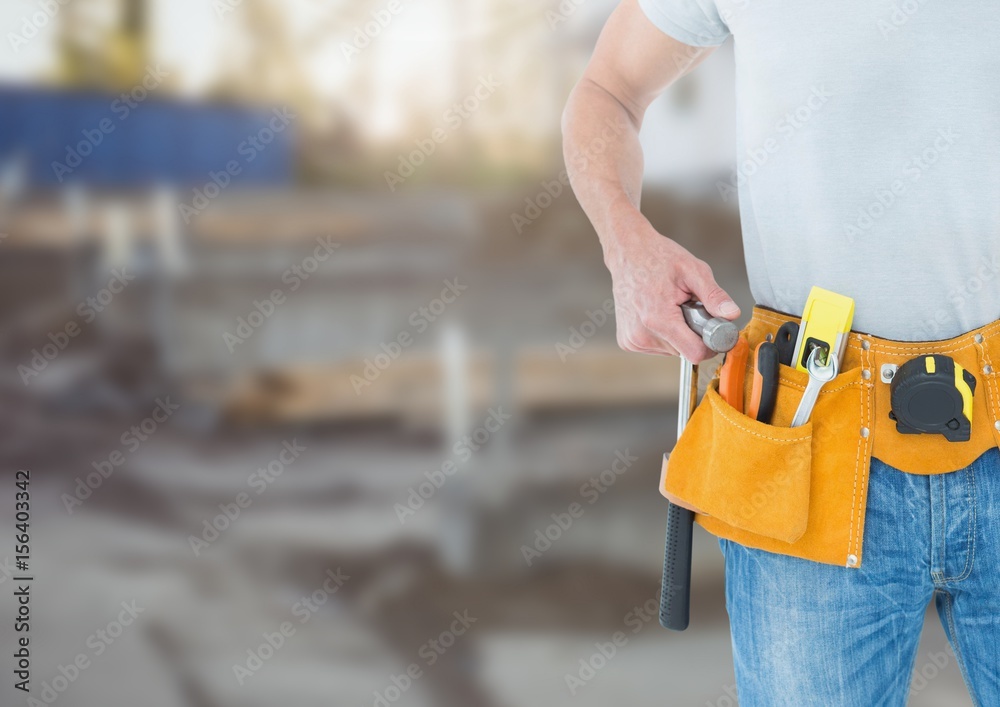 Carpenter with tools on building site