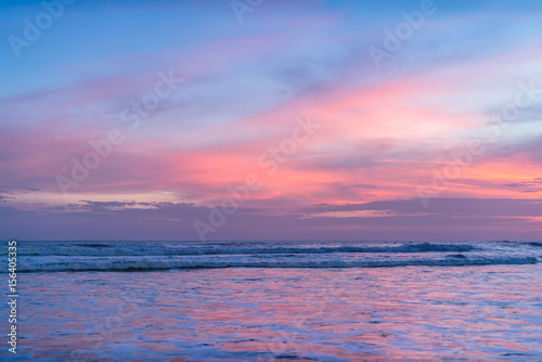 Background Sunset Ocean. Clean Water, Waves, colored Sky, Horizon. Background Tropical Island Seascape. Sea water Surface, Sea water Texture, Nature, Resort, Sea Vacation. Pink Ocean Background