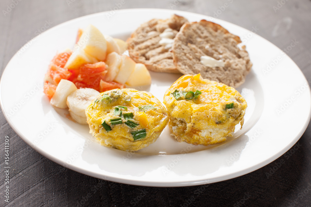 Egg Muffin Cups with side of Oranges and Banana Fruit Salad plus two slices of Toast topped with butter horizontal shot
Egg Muffin Cups with side of Oranges and Banana Fruit Salad plus two slices of Toast topped with butter horizontal shot