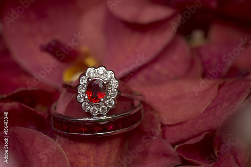 red gemstone ring on rose © Bordin