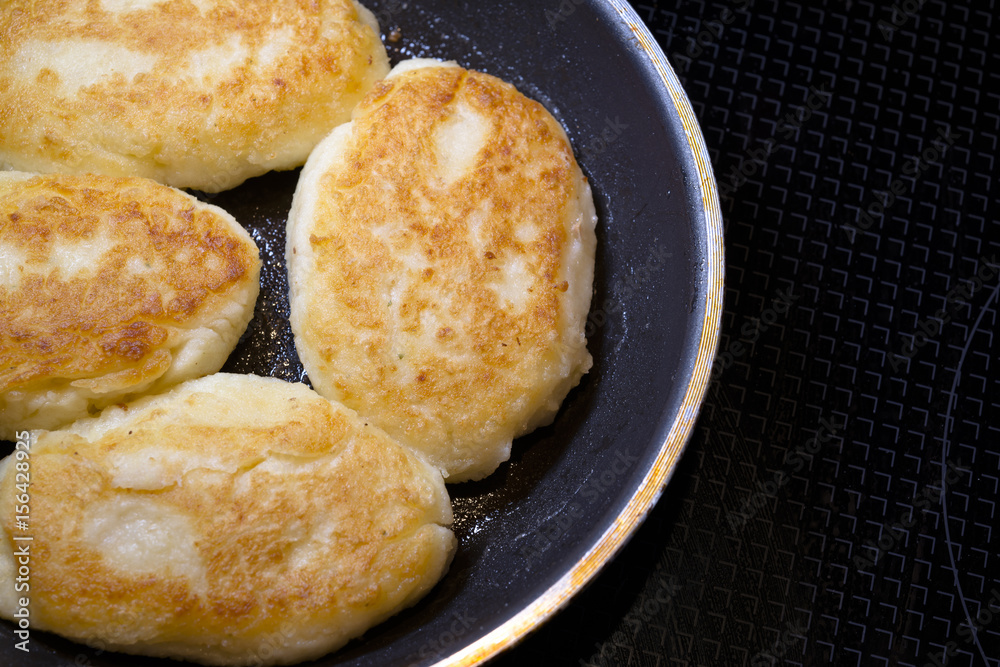 Fried delicious Ukrainian cuisine potato patties in frying pan