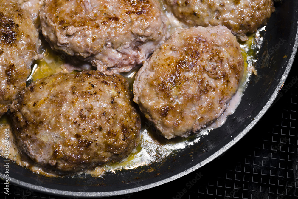 Beef Meat patties fried with oil on frying pan Beef Meat patties fried with oil on frying pan