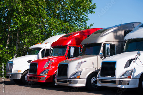 Semi trucks models in row on truck stop parking lot photo