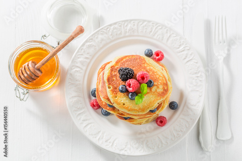 Yummy american pancakes with blueberries and raspberries