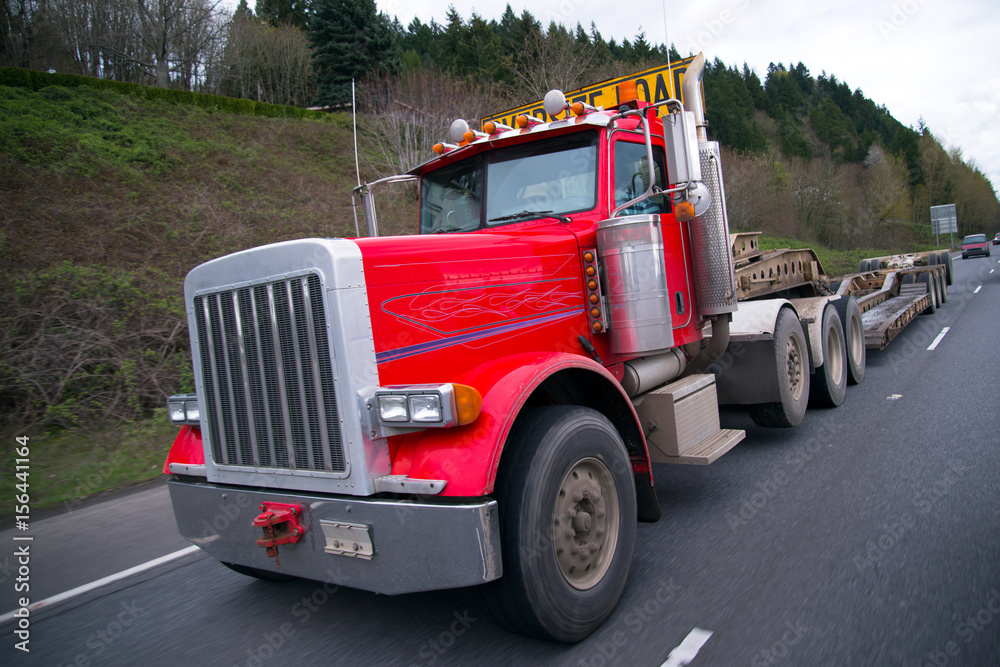 Big rig red semi truck with oversize flat bed