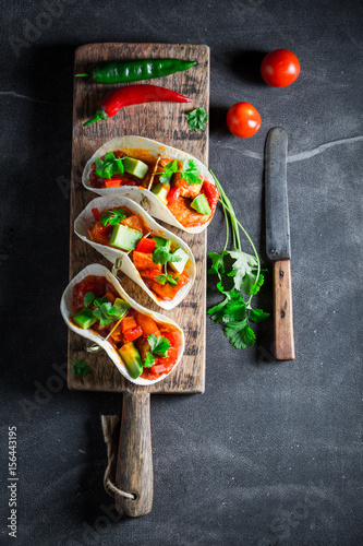 Delicious tacos with avocado, lime and tomato sauce