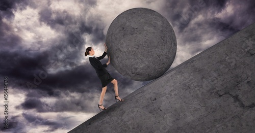 Businesswoman pushing a 3D stone ball above her