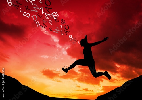 woman jumping in the mountain silhouette