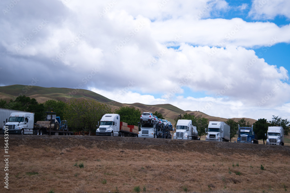 Semi trucks stop in row on California rest area Semi trucks stop in row on California rest area