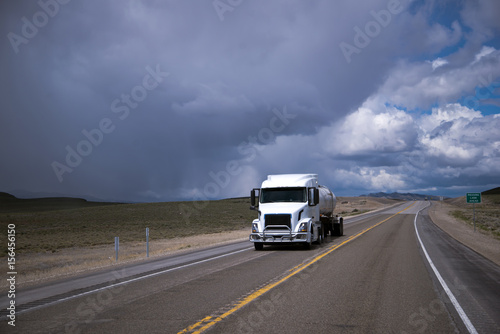 White semi-truck with tank trailer transporting liquid in Nevada