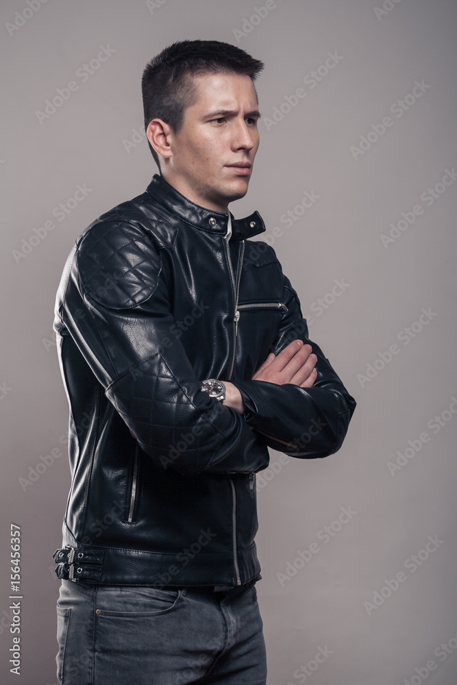 Fototapeta premium young man, sideways, looking sideways ,leather jacket,