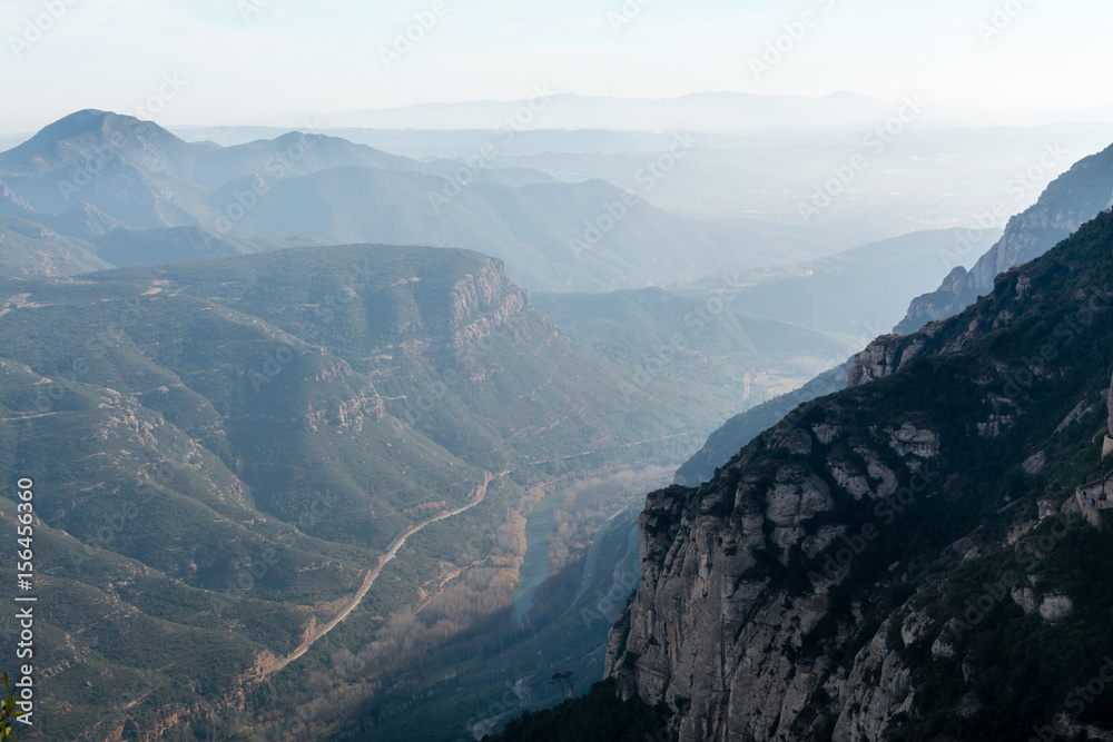 Mountain landscape,  rocky cliffs and misty ridges in range