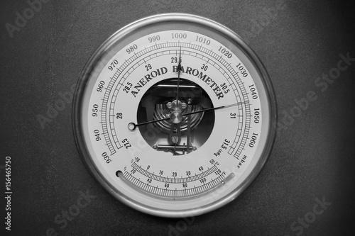 Old round barometer meter isolated over black background