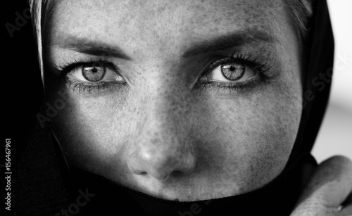 Woman face with deep eyes portrait, black and white photo session in the arabic style, monochrome, deep strong eyes photo