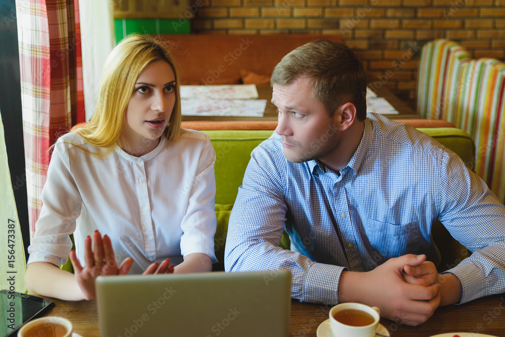 Business meeting in a cafe. Man and woman are negotiating