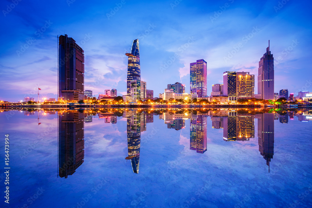 Cityscape in reflection of Ho Chi Minh city at beautiful twilight, viewed over Saigon river. Hochiminh city is the largest city in Vietnam with population around 10 million people