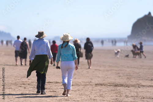 People happily walking along the shore of the Pacific ocean