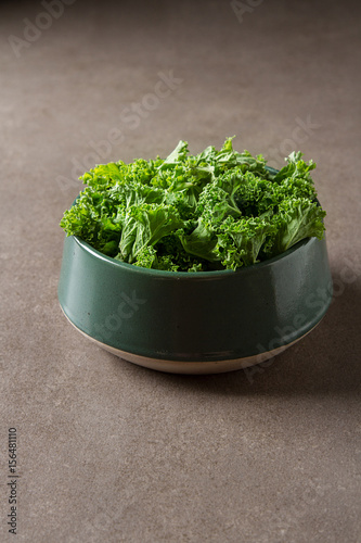 Fresh green Italian salad Kale. Dark background. © naltik