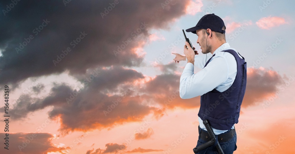 Fototapeta premium Security guard gesturing and talking on walkie 