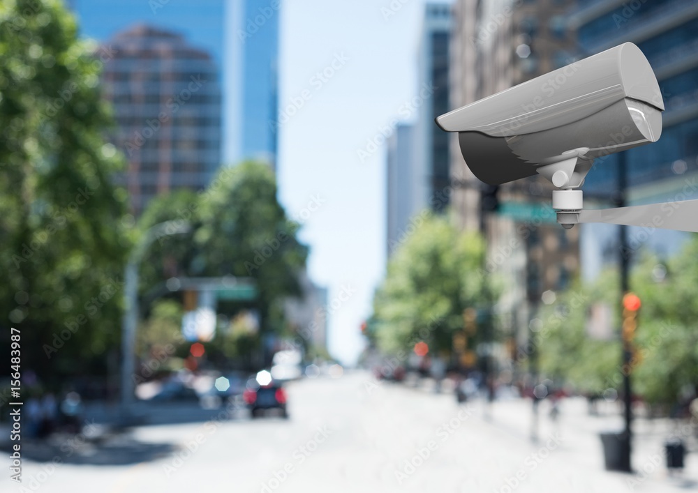 Obraz premium CCTV camera against defocused buildings